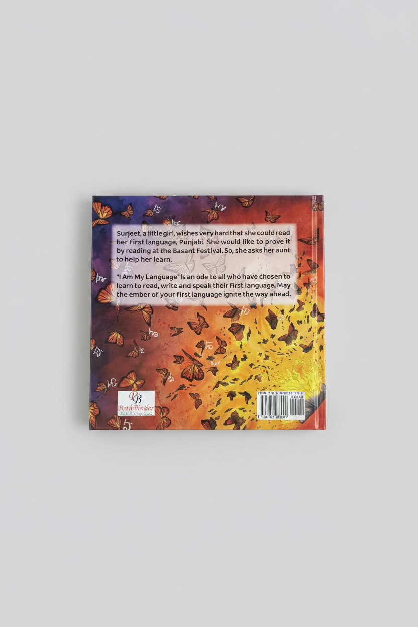 The back cover of a children's book titled 'Am My Language' by Ritu Anand, featuring a vibrant background of orange, yellow, and purple with illustrations of butterflies and Punjabi/English text, photographed on a dark gray surface.