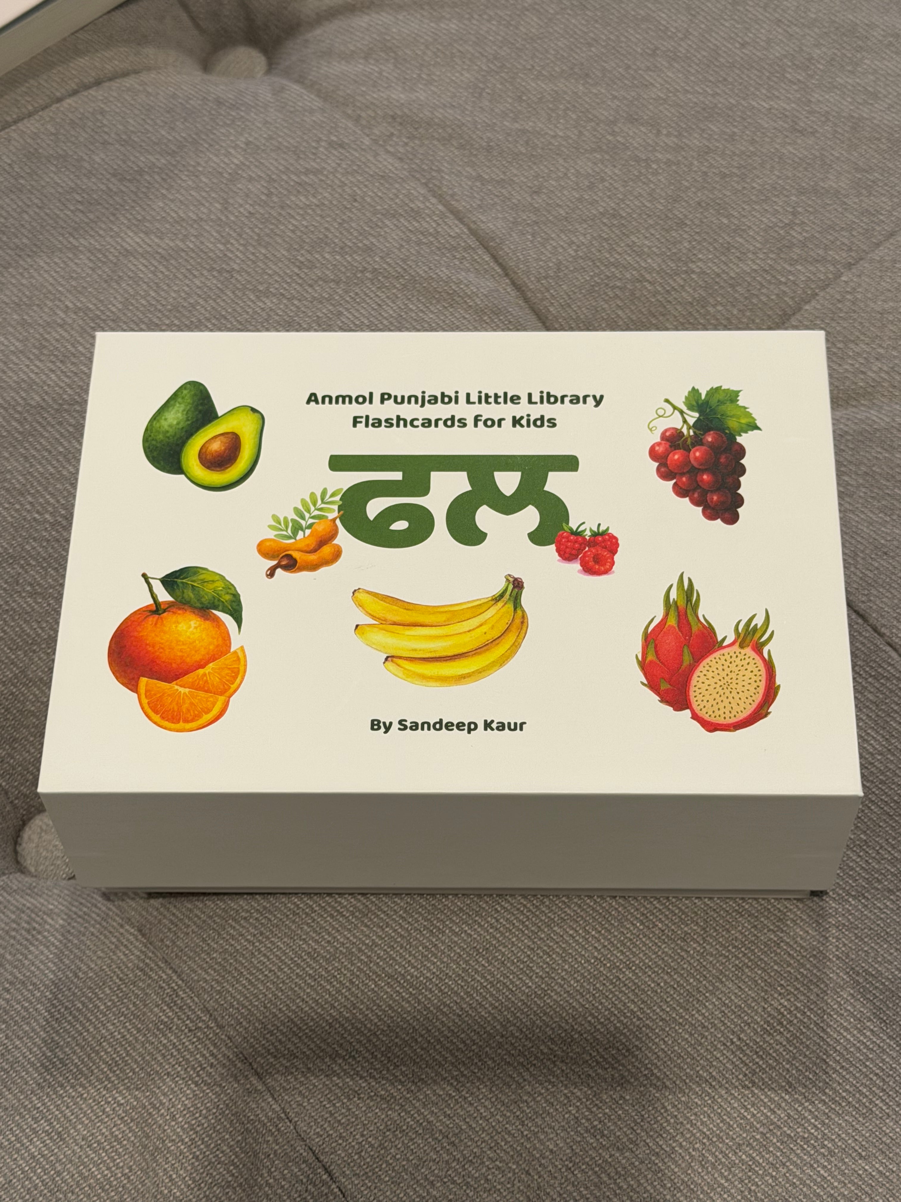 Flashcards for kids with illustrations of fruits on a gray surface
